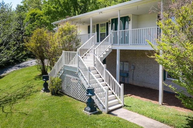 view of home's exterior featuring a porch and a yard