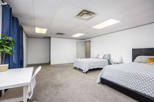 carpeted bedroom with a drop ceiling