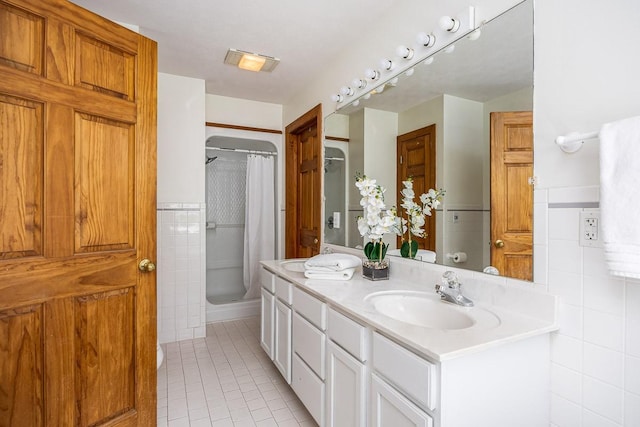 bathroom featuring tile patterned flooring, vanity, and a shower with shower curtain