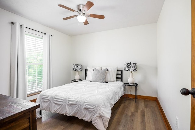 bedroom with dark hardwood / wood-style floors and ceiling fan