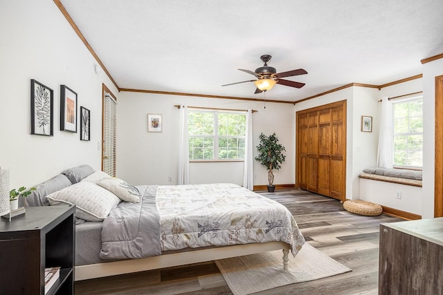 bedroom featuring crown molding, light hardwood / wood-style flooring, and ceiling fan