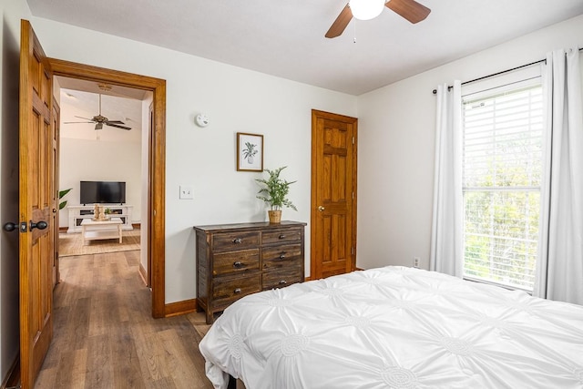 bedroom featuring dark hardwood / wood-style flooring and ceiling fan