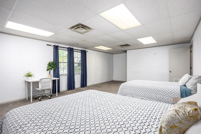 bedroom with light carpet and a paneled ceiling