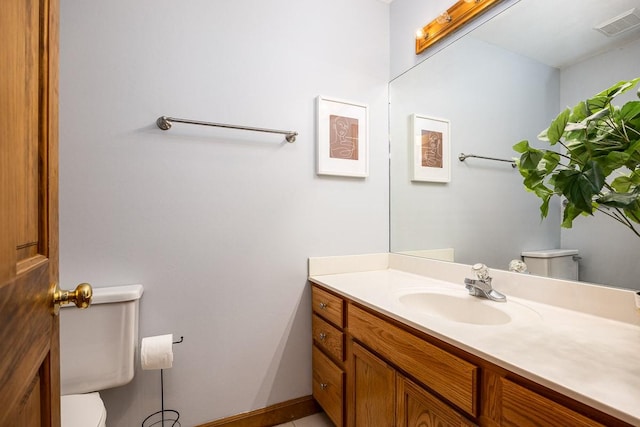 bathroom featuring vanity and toilet