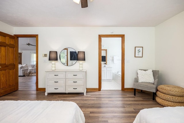 bedroom with dark hardwood / wood-style floors, ceiling fan, and ensuite bathroom