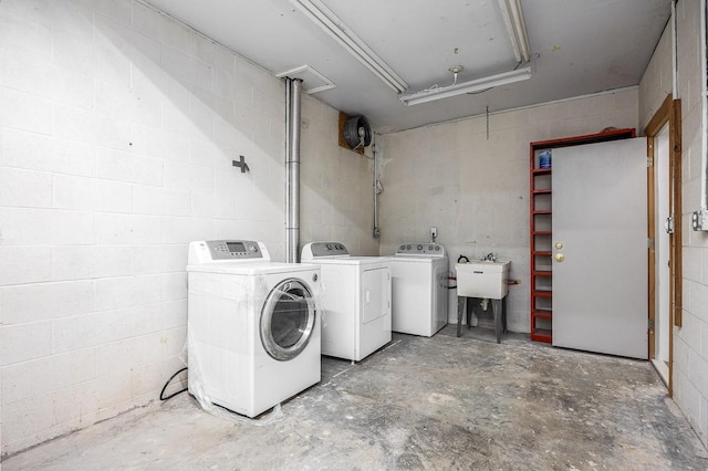 washroom with sink and washing machine and clothes dryer