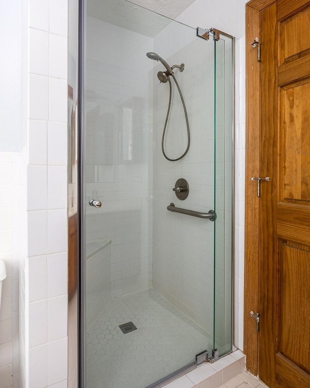 bathroom with a shower with shower door