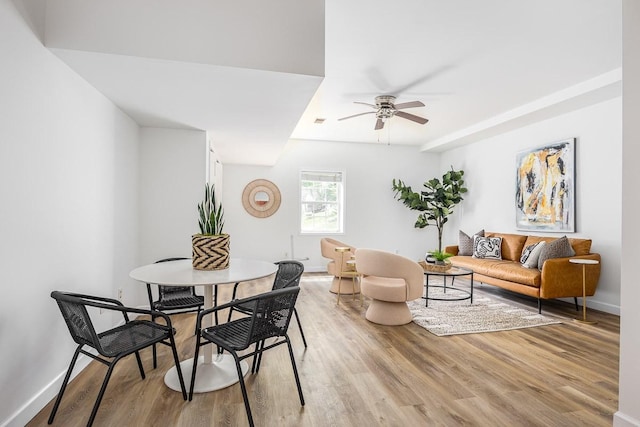 dining area with ceiling fan and light hardwood / wood-style flooring