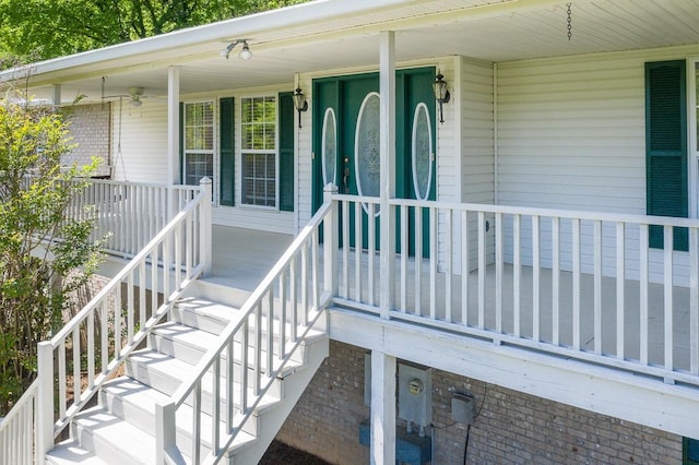 view of exterior entry featuring covered porch