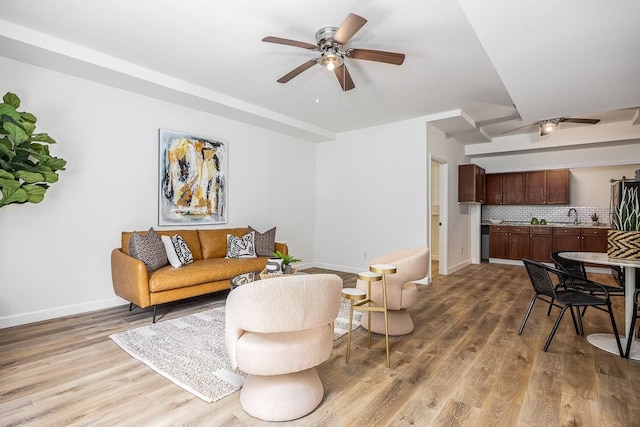 living room featuring hardwood / wood-style floors and ceiling fan