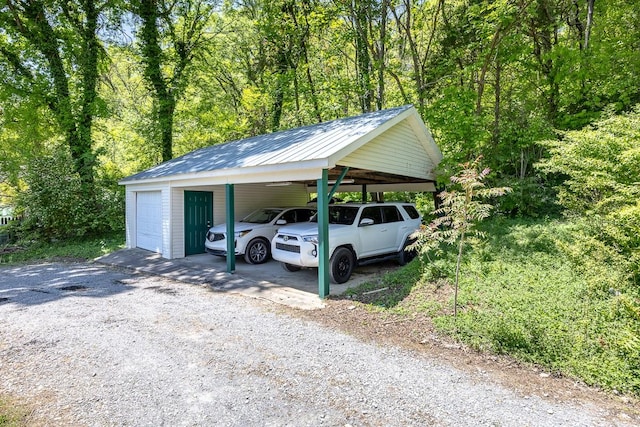 view of parking with a carport and a garage