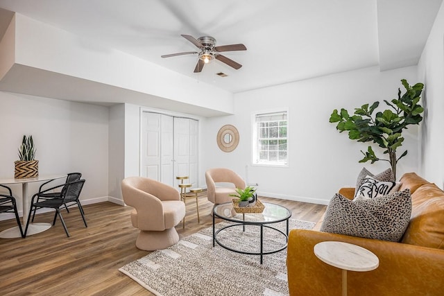 living room featuring hardwood / wood-style flooring and ceiling fan