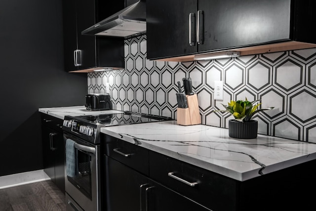 kitchen featuring stainless steel electric range, light stone countertops, dark hardwood / wood-style floors, and decorative backsplash