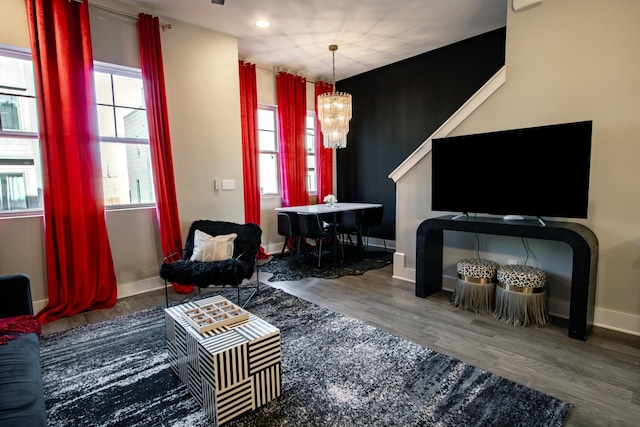 living room featuring dark hardwood / wood-style floors and a chandelier