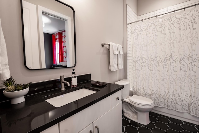 bathroom with vanity, tile patterned floors, and toilet