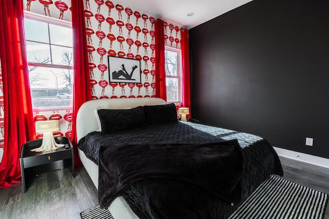 bedroom with dark hardwood / wood-style floors