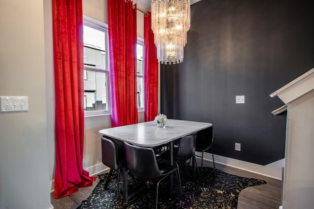 dining room featuring wood-type flooring and a notable chandelier