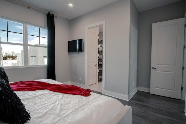 bedroom with dark wood-type flooring