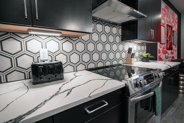 kitchen featuring tasteful backsplash, stainless steel electric range, light stone countertops, and wall chimney exhaust hood