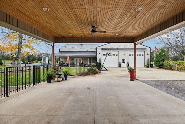 view of patio with ceiling fan and a garage