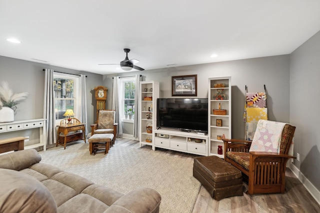 living room featuring ceiling fan and hardwood / wood-style floors