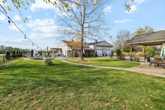 view of yard featuring a garage, a gazebo, and a patio area