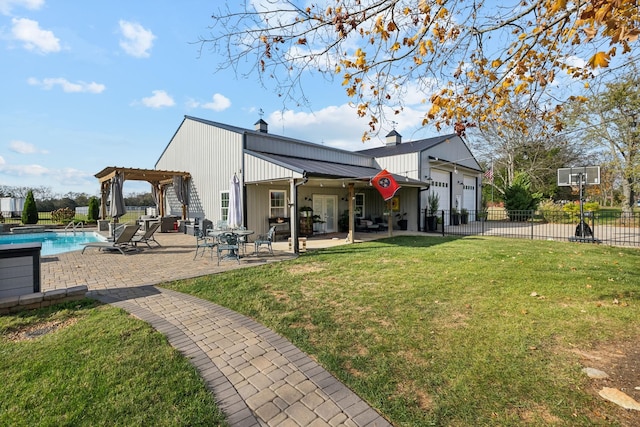 back of property featuring a fenced in pool, a lawn, a pergola, a patio, and a garage