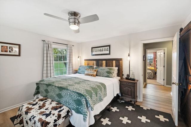 bedroom with light hardwood / wood-style floors and ceiling fan