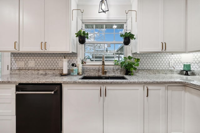 kitchen featuring light stone counters, sink, tasteful backsplash, and white cabinets