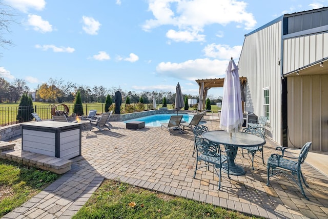 view of patio featuring a fenced in pool, an outdoor fire pit, and a pergola