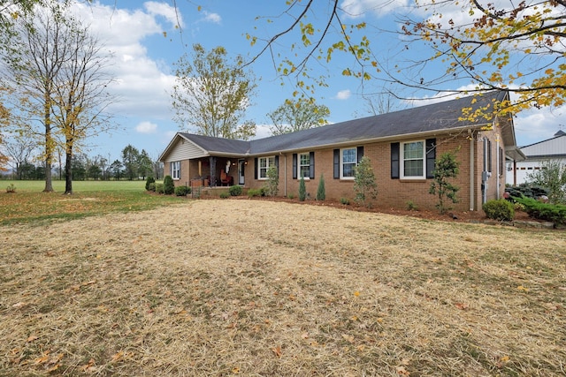 ranch-style house with a front yard and covered porch