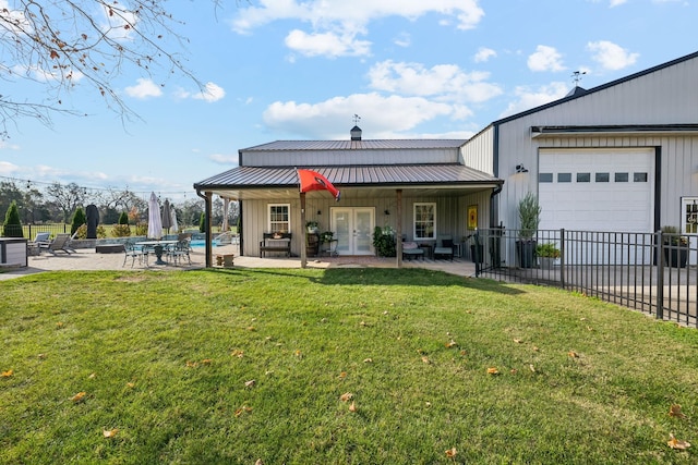 rear view of house featuring french doors, a patio area, and a lawn