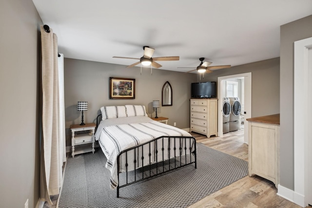 bedroom with ceiling fan, washer and clothes dryer, and light wood-type flooring