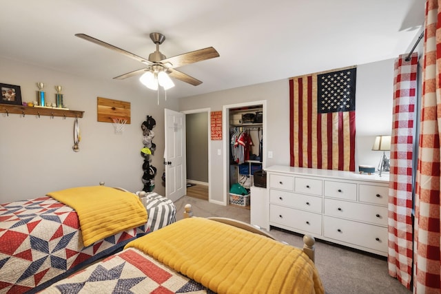 carpeted bedroom with ceiling fan and a closet