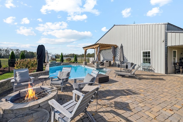 view of swimming pool with an outdoor fire pit, a pergola, and a patio area