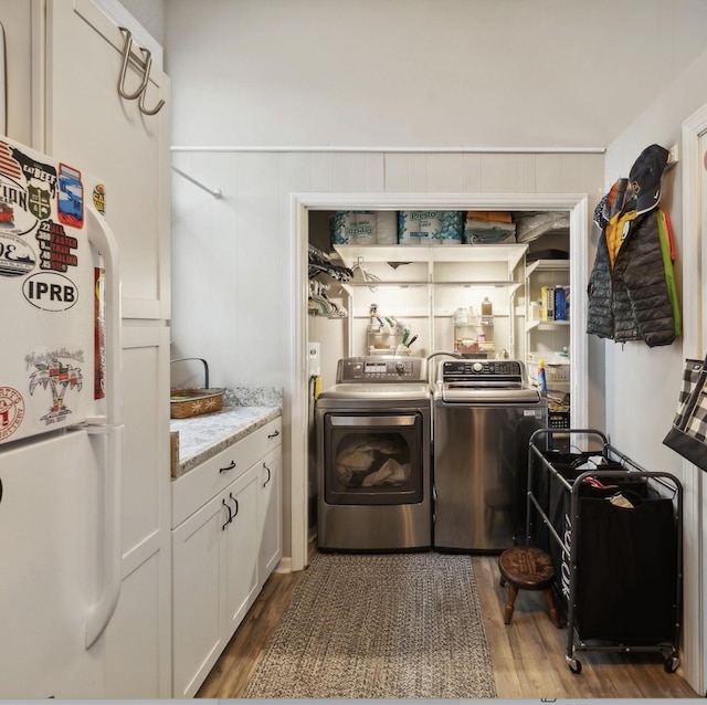 washroom with separate washer and dryer and dark hardwood / wood-style floors