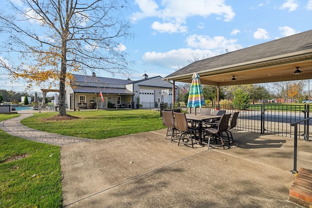 view of patio / terrace featuring a pool and ceiling fan