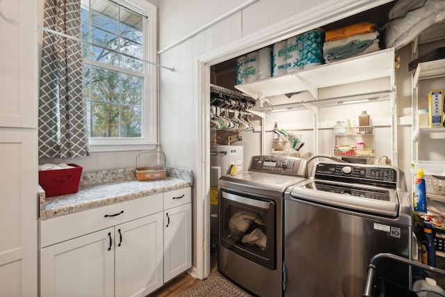 laundry area featuring washer and clothes dryer and electric water heater