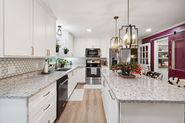 kitchen featuring white cabinetry, appliances with stainless steel finishes, and a center island