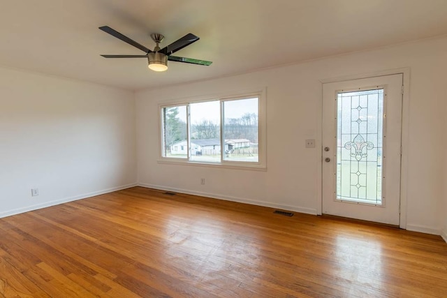 foyer entrance featuring ceiling fan, a healthy amount of sunlight, and light wood-type flooring