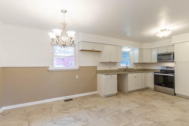 kitchen featuring decorative light fixtures, sink, white cabinets, a chandelier, and stainless steel appliances