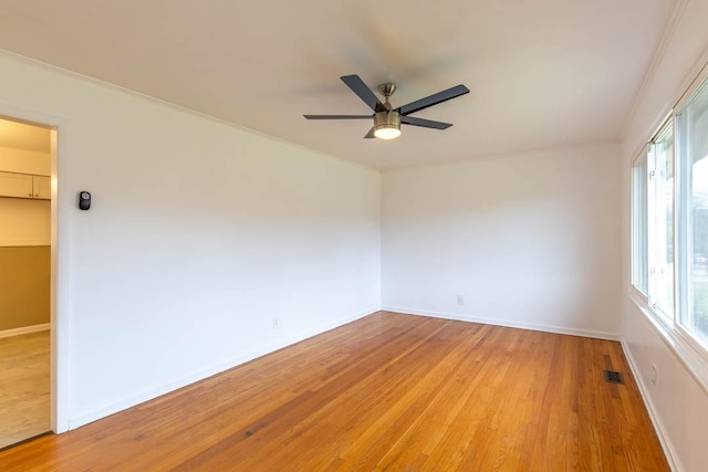 empty room with ceiling fan and light wood-type flooring