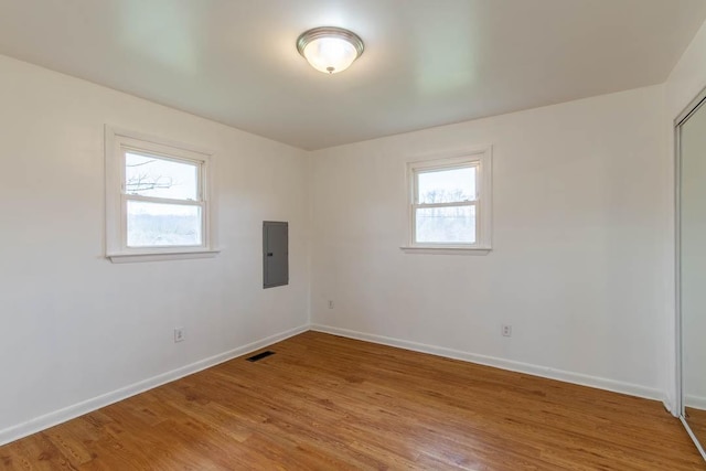 unfurnished room featuring light hardwood / wood-style flooring and electric panel