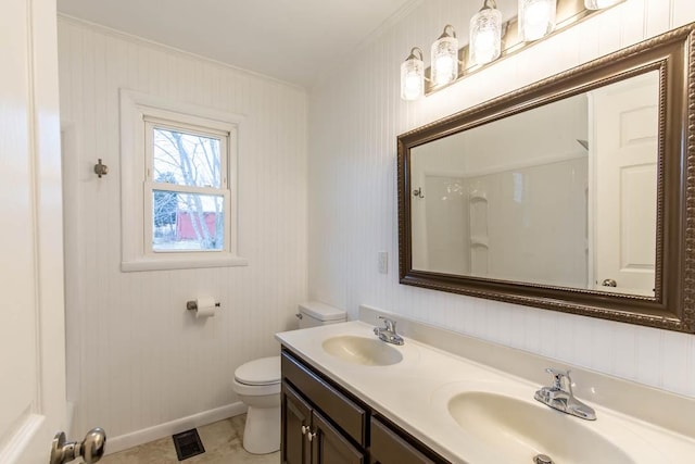 bathroom featuring crown molding, tile patterned flooring, vanity, toilet, and walk in shower