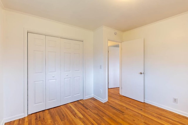 unfurnished bedroom with a closet and light wood-type flooring