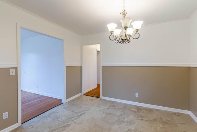 empty room featuring crown molding and a chandelier