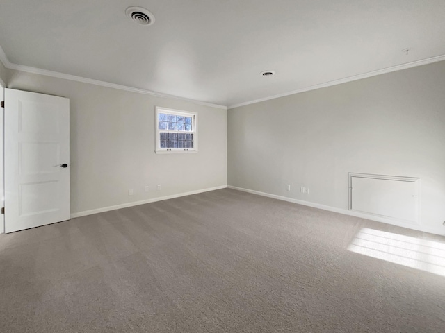 unfurnished room with crown molding and carpet floors