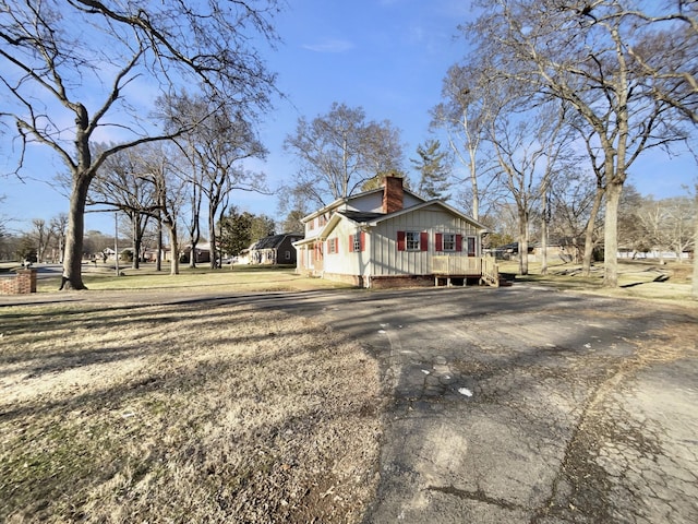 view of home's exterior featuring a deck and a lawn