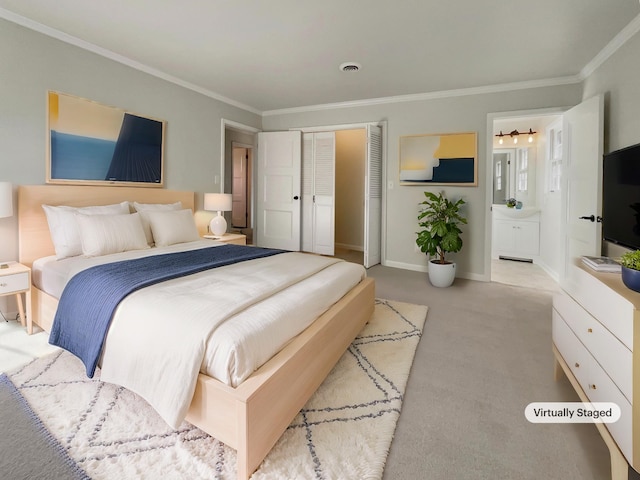 carpeted bedroom with crown molding and ensuite bathroom