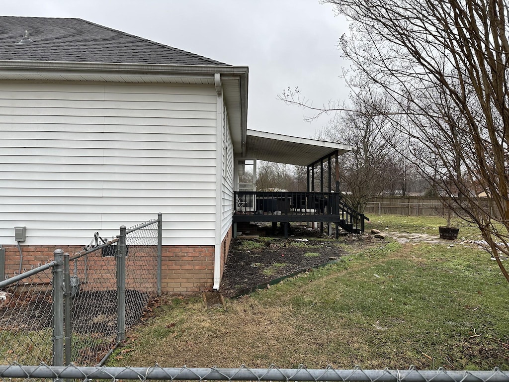 view of property exterior featuring a wooden deck and a lawn